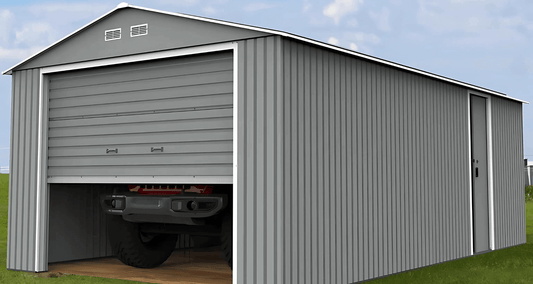 Detached garage with a vehicle inside, showcasing durable Duramax construction in a grassy outdoor setting.