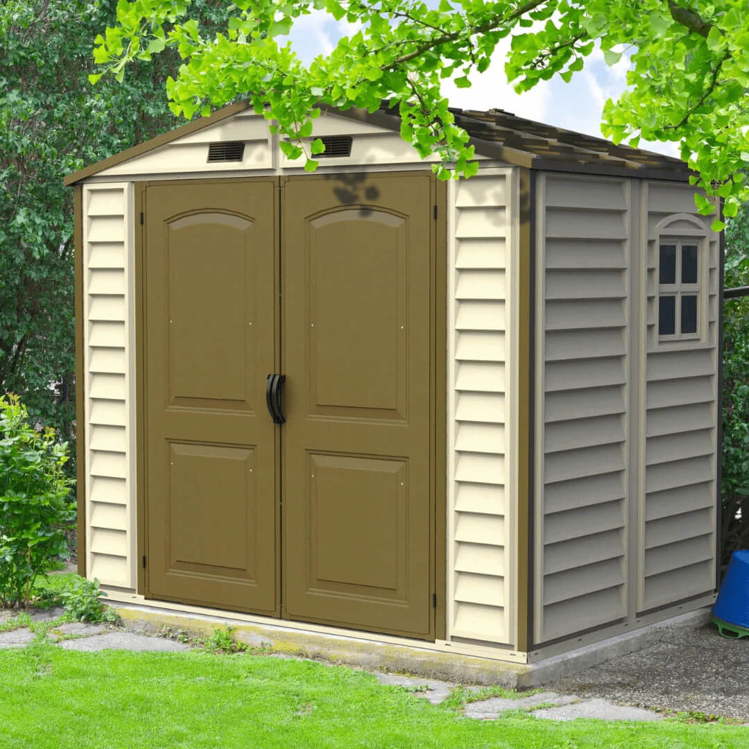 Duramax vinyl shed with a brown door, nestled in a green garden setting, ideal for outdoor storage solutions.