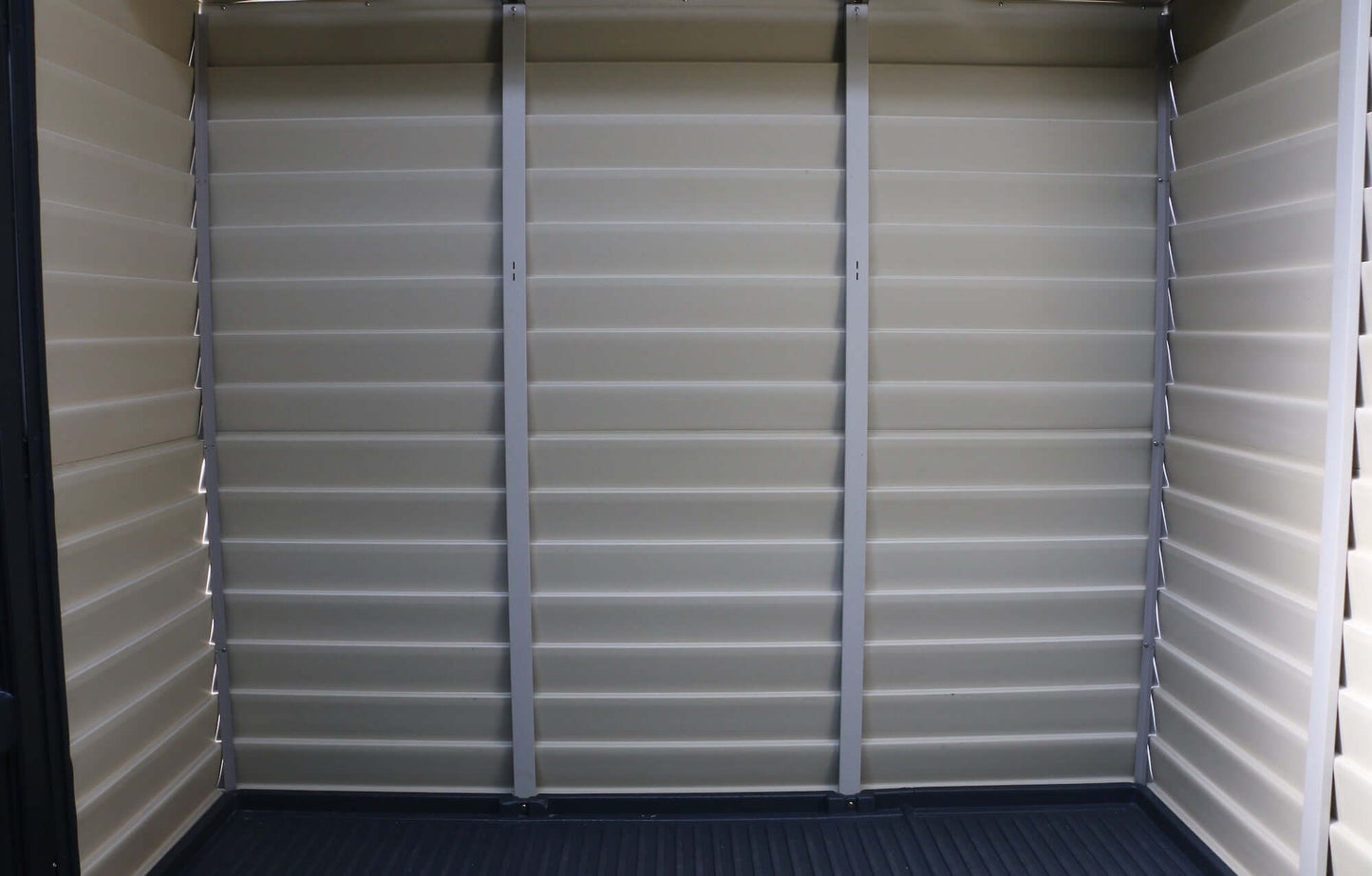 Interior view of Duramax 10x8 StoreMax PLUS Vinyl Shed with all-weather vinyl floor, showcasing durability and spacious design.