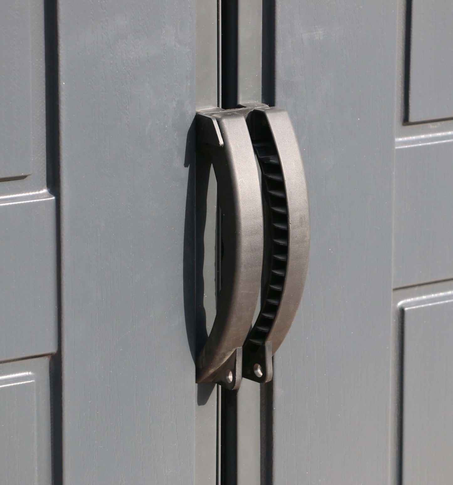 Close-up of door handle on Duramax 10x8 StoreMax PLUS Vinyl Shed with Floor, demonstrating its durable construction.