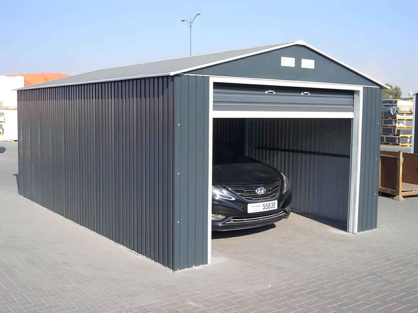 Duramax Imperial Metal Garage 12x20 in light gray, featuring high-quality steel construction with car parked inside.