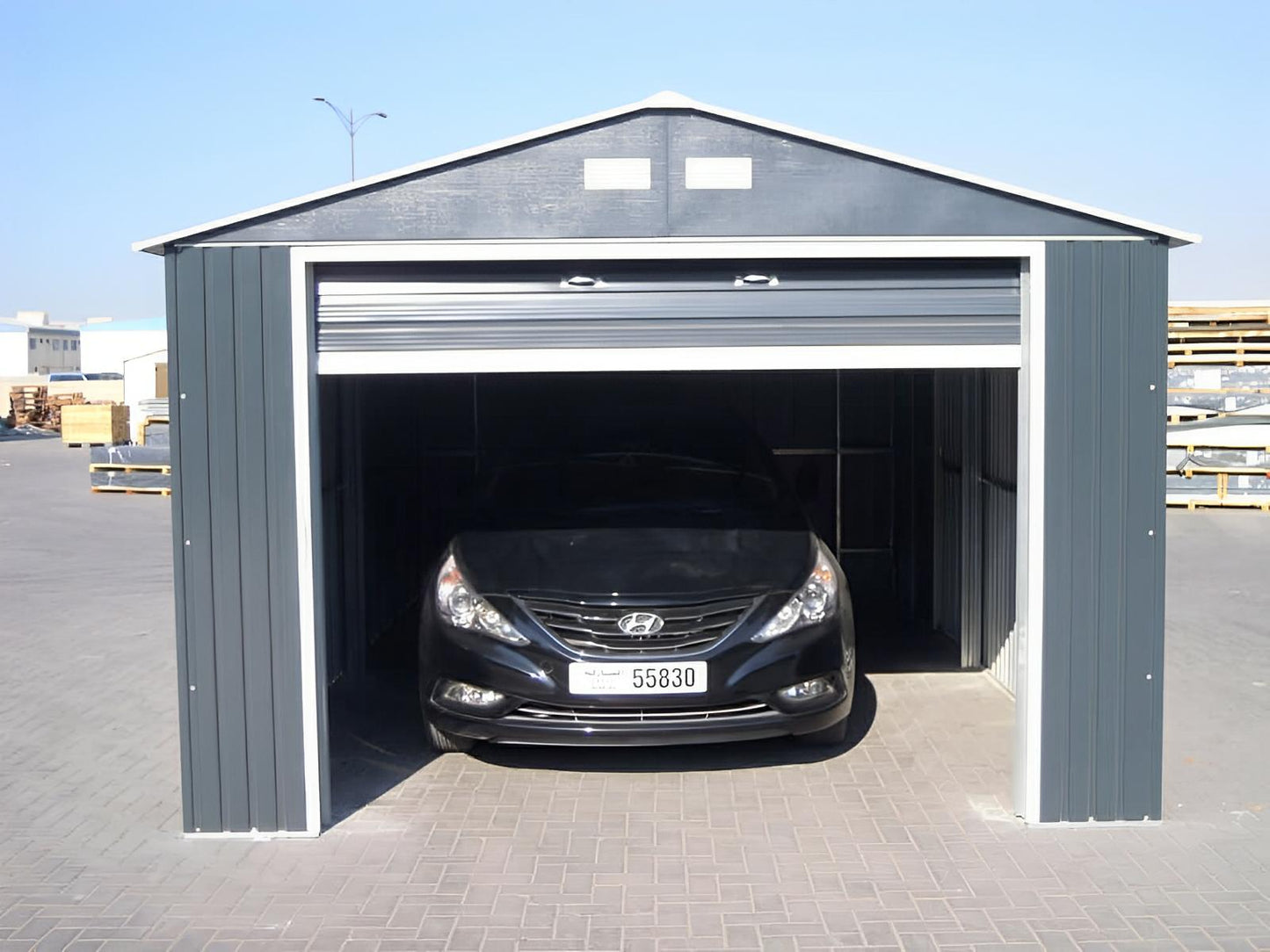 Duramax 12x20 Imperial Metal Garage in light gray with an open door revealing a car inside.