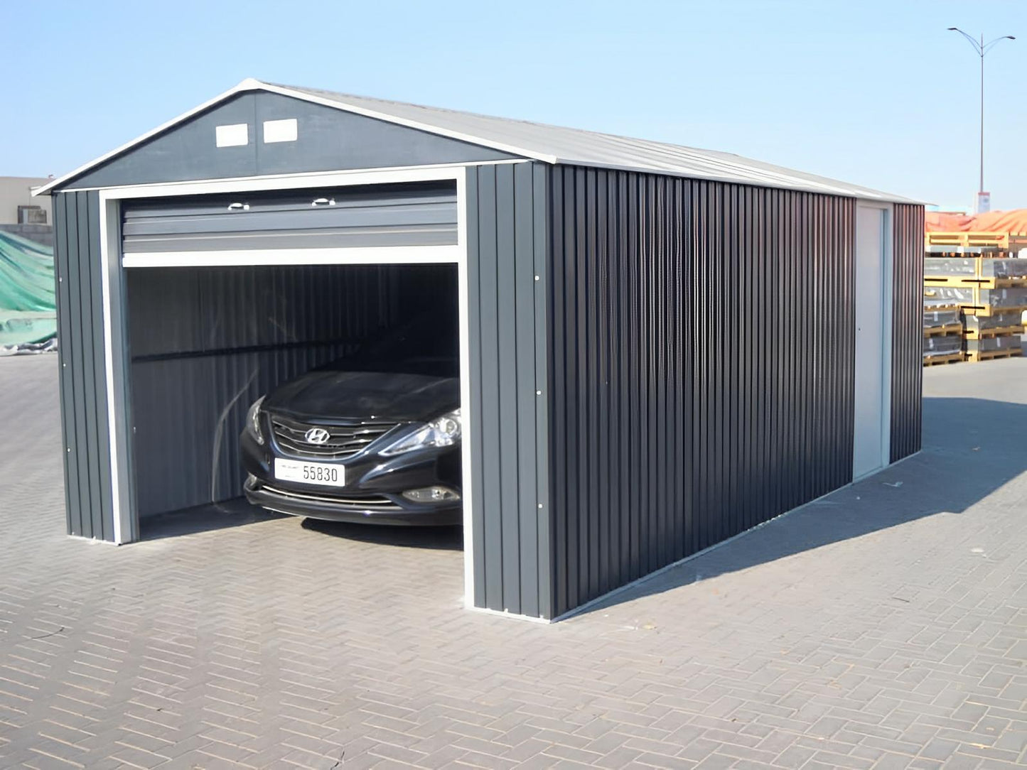 Duramax 12x20 Imperial Metal Garage in light gray with a car parked inside, showcasing durability and ample storage space.