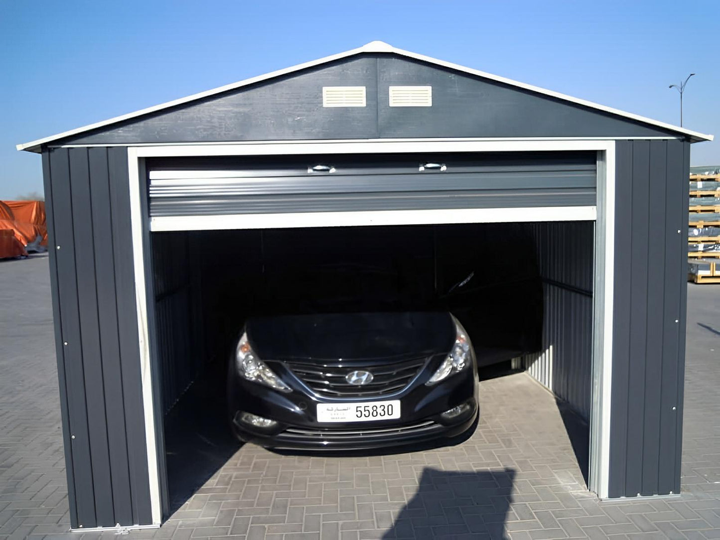 Duramax 12x20 Imperial Metal Garage in light gray with car inside, showcasing durability and protection, 10-year warranty included.