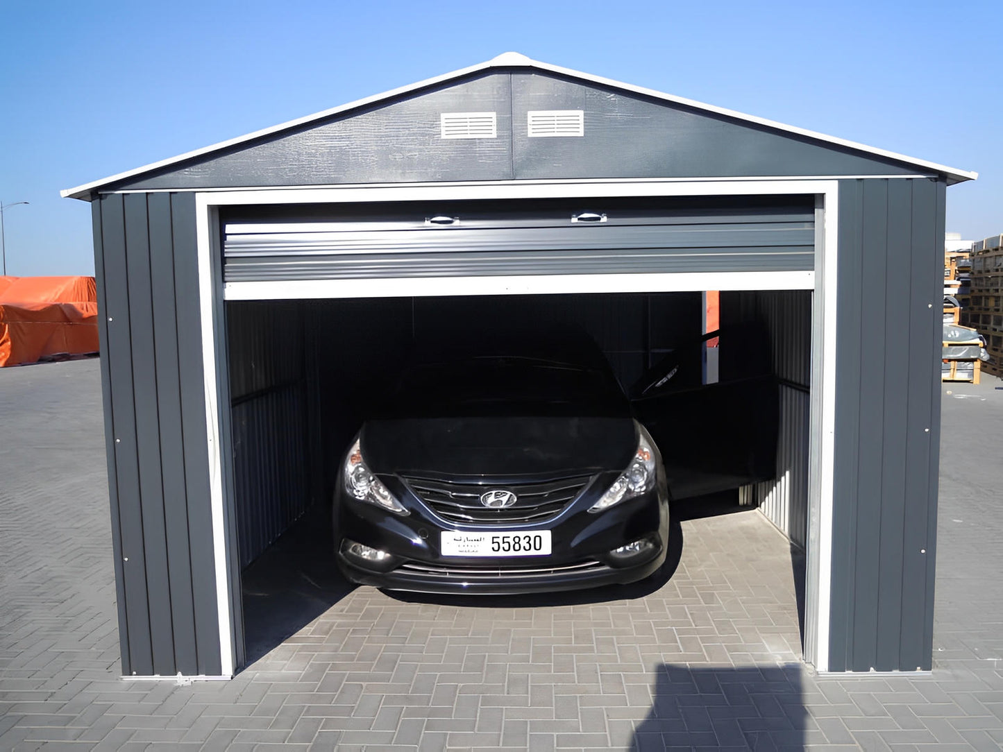 Duramax 12x26 Imperial Metal Garage in light gray housing a car, showcasing its strength and security features.