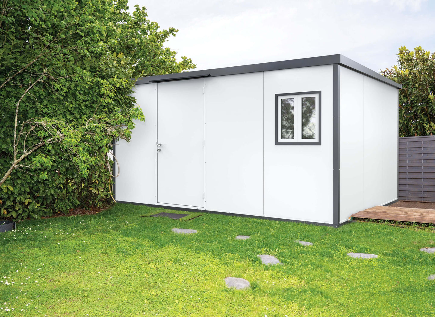 Duramax 13x10 flat roof insulated building in garden setting, ideal storage solution. Keywords: Duramax, insulated building, insulated shed.