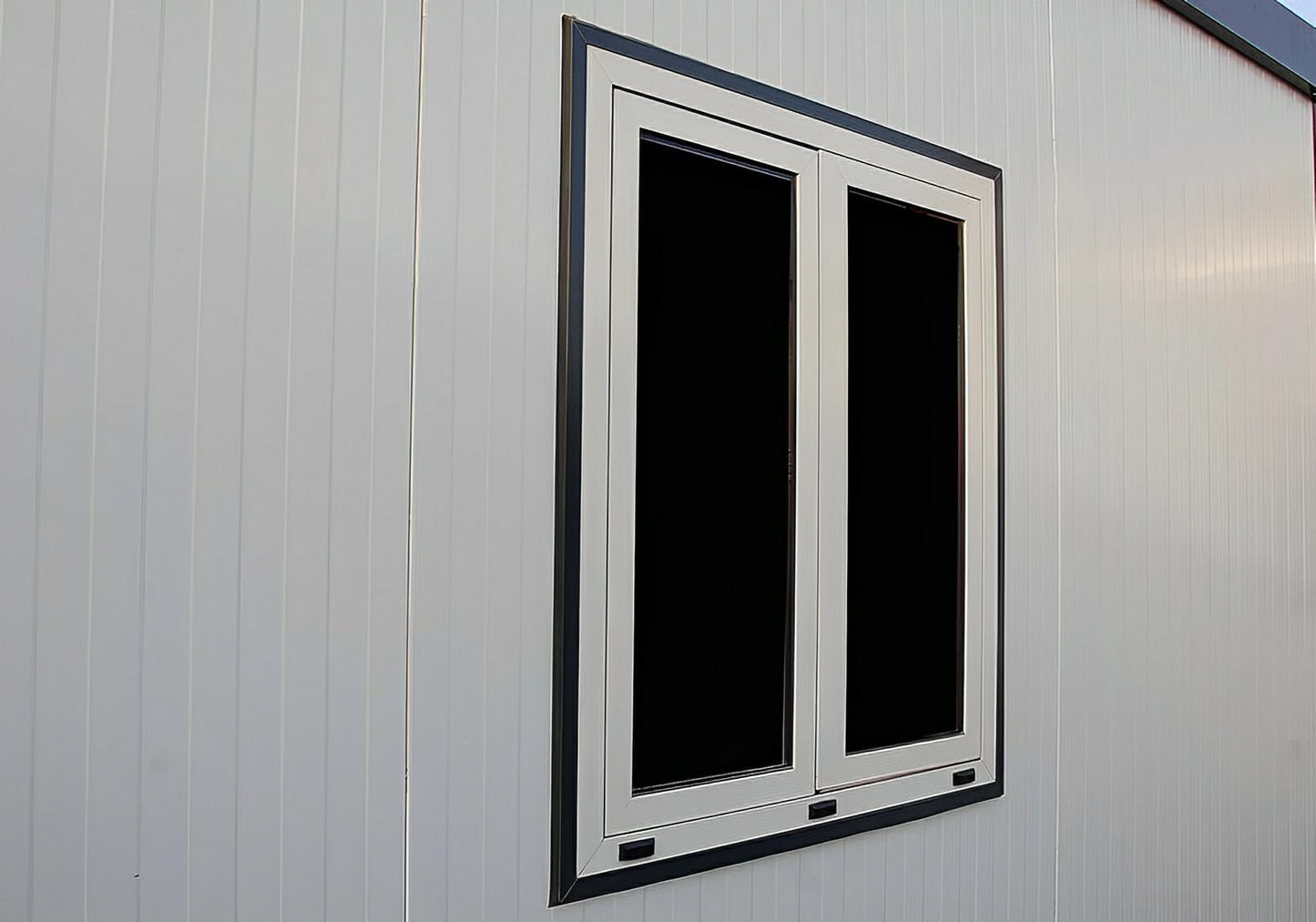 Close-up of a window on the Duramax 22x10 insulated building, showcasing the modern, prefabricated design and durable materials.
