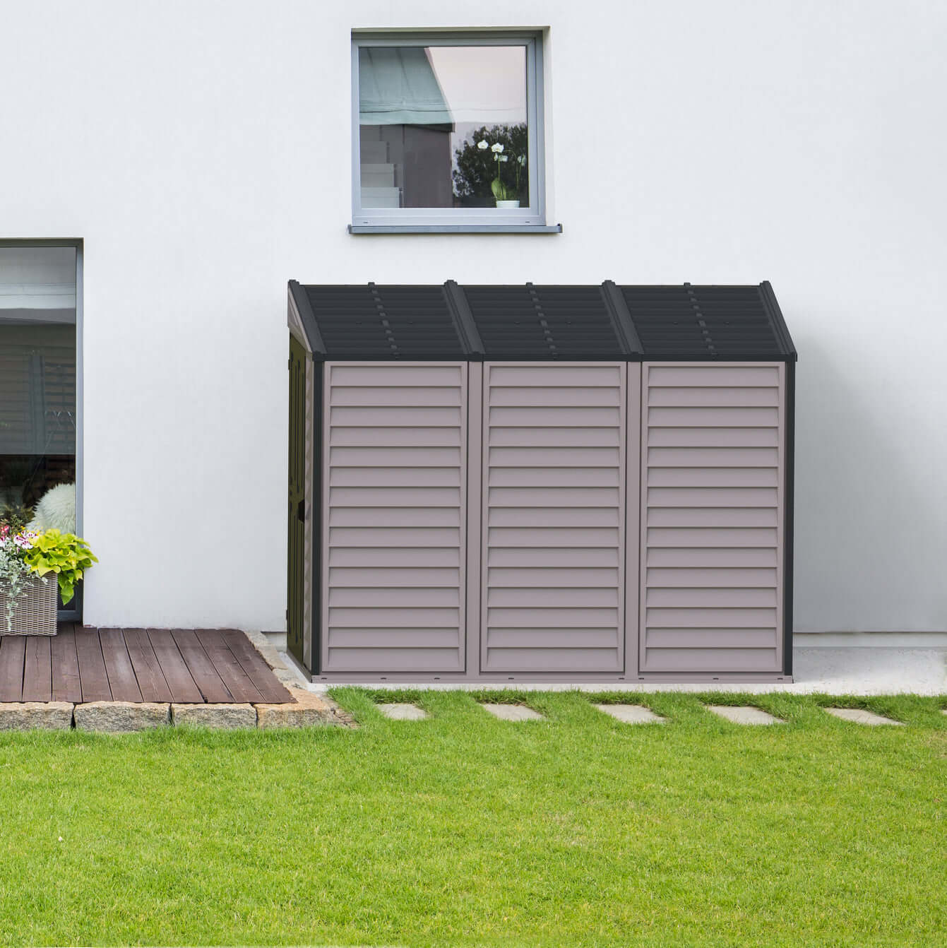 Duramax 4x8 SideMate PLUS Vinyl Shed in Grey, ideal for backyard storage, fitting neatly alongside a house.