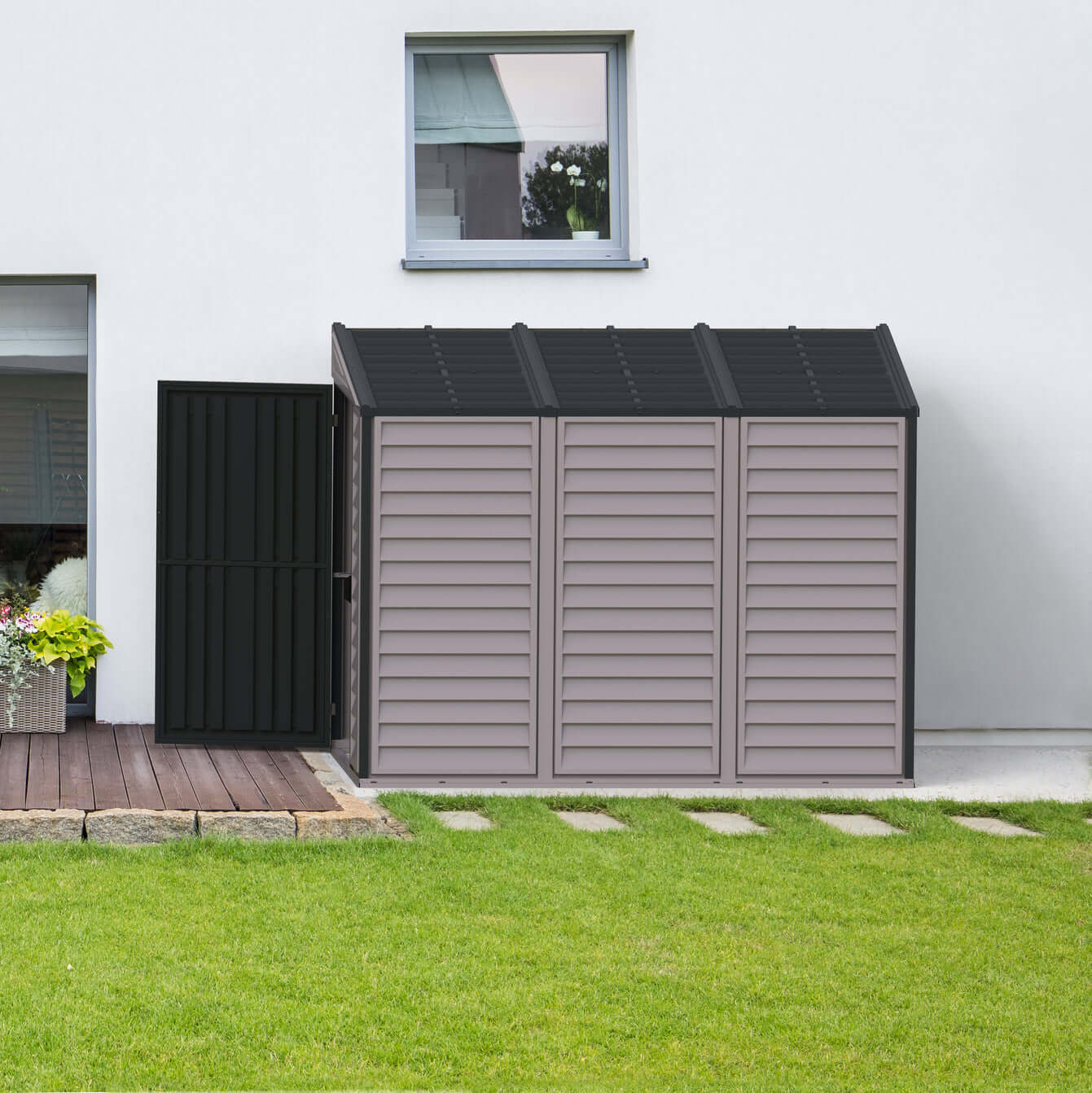 Duramax 4x8 SideMate PLUS vinyl shed in grey beside a home, ideal for outdoor storage. Durable all-weather design. Keywords: Duramax shed.