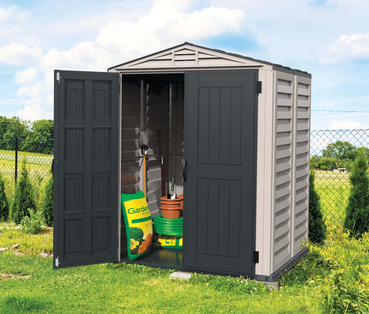 Duramax 5x5 YardMate PLUS Vinyl Shed with open doors displaying gardening tools and supplies.