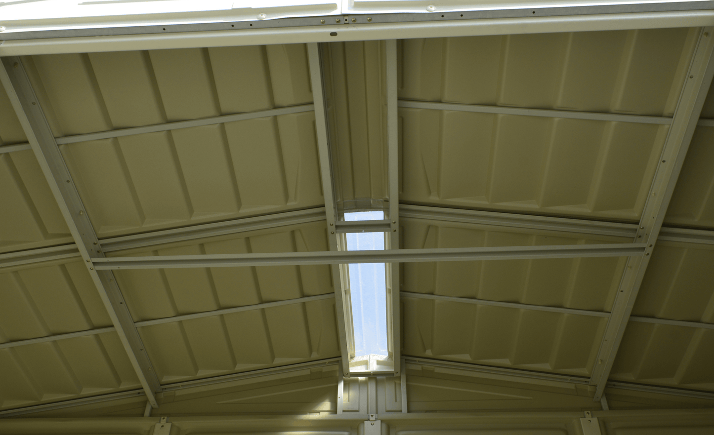 Interior view of a Duramax 8x8 DuraMate vinyl shed roof showing metal reinforcement beams and ceiling design.