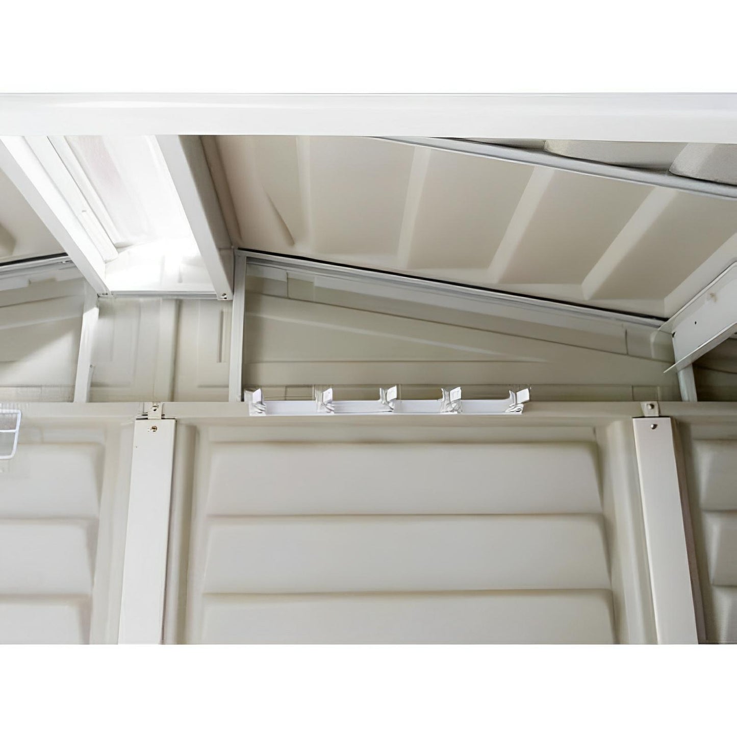 White steel multi-tool hanger in a Duramax shed for organizing tools, featuring five spring-loaded clasps for brooms and rakes.