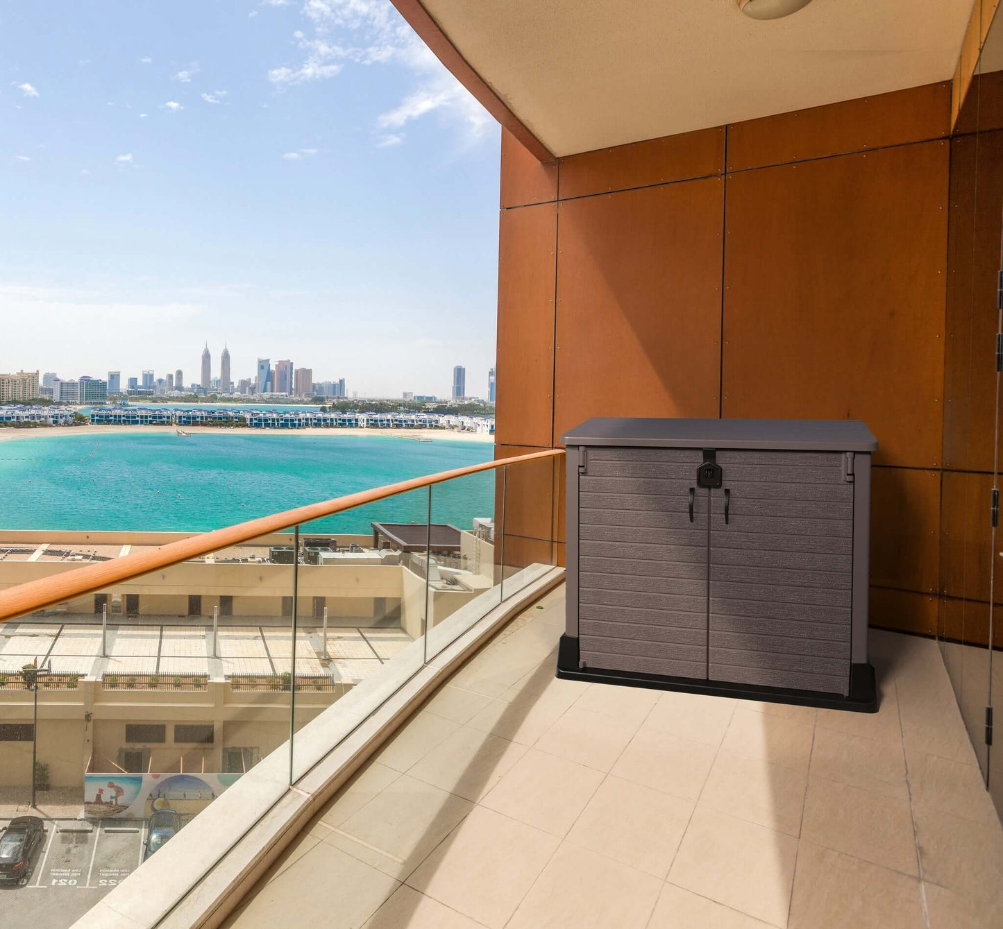Duramax Storeaway garden shed on a balcony overlooking cityscape and water, showcasing outdoor storage solution.
