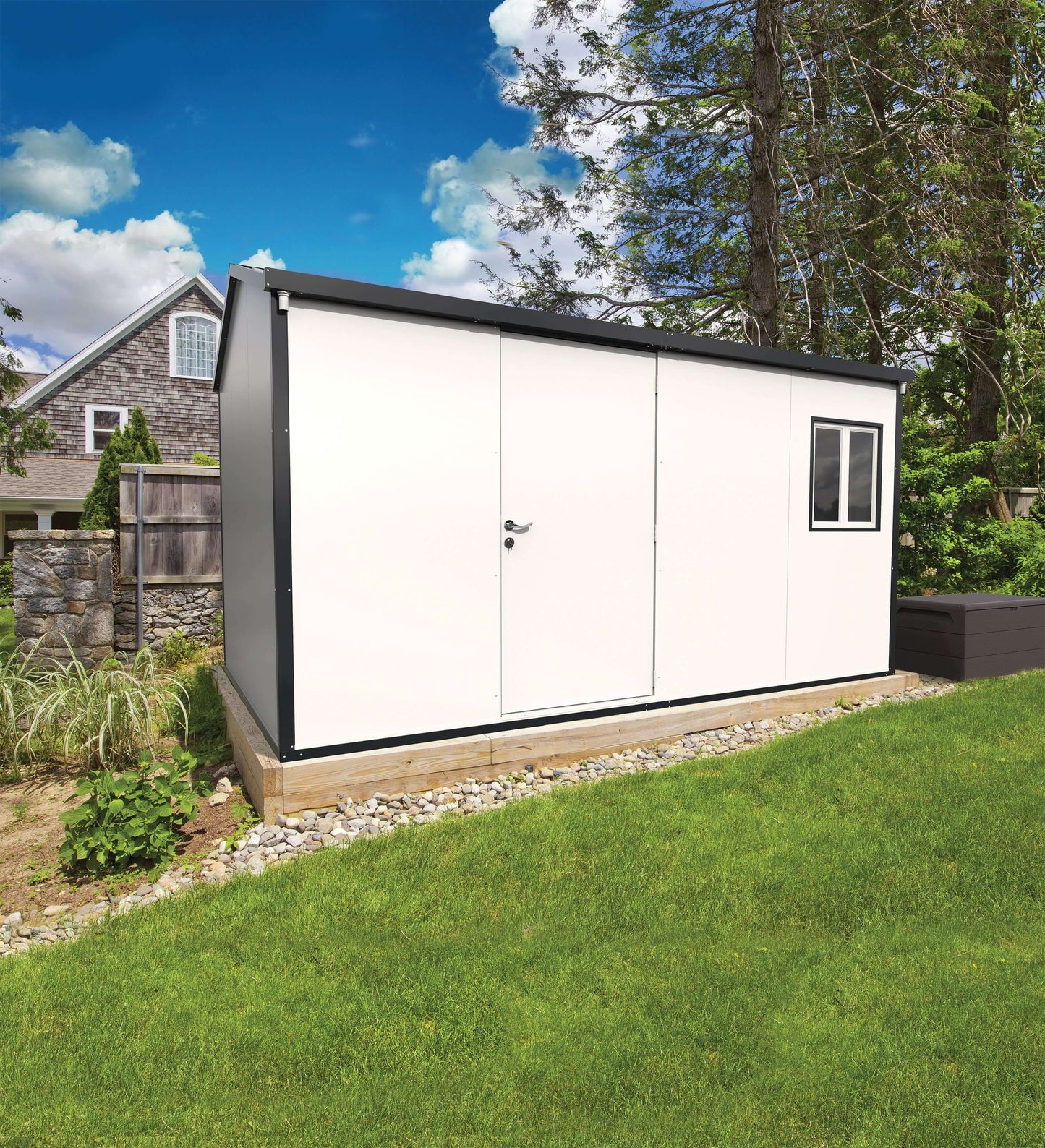 Duramax 13x10 Insulated Shed with gable roof in garden setting, showcasing durable pre-painted galvanized steel walls.