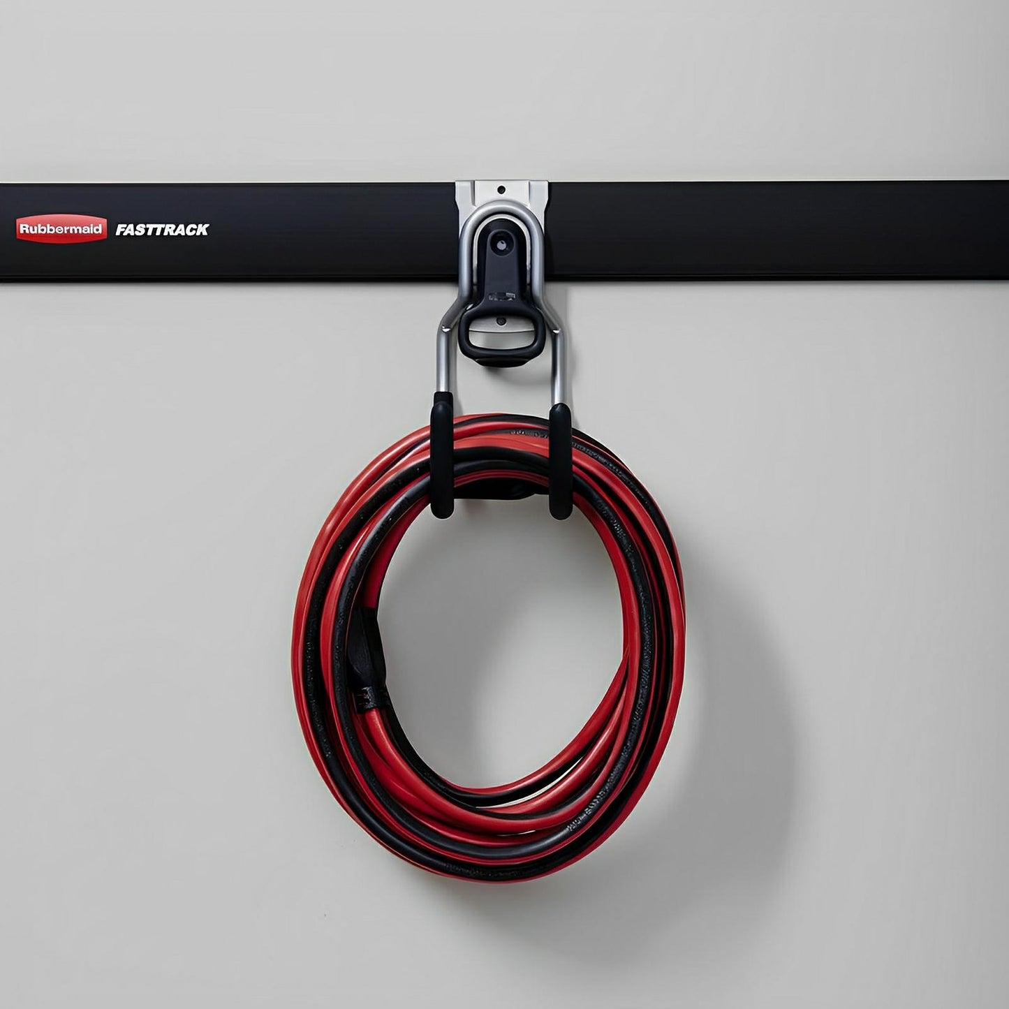 Rubbermaid FastTrack Storage System with Multi-Purpose Hook holding a coiled red and black hose for shed organization.