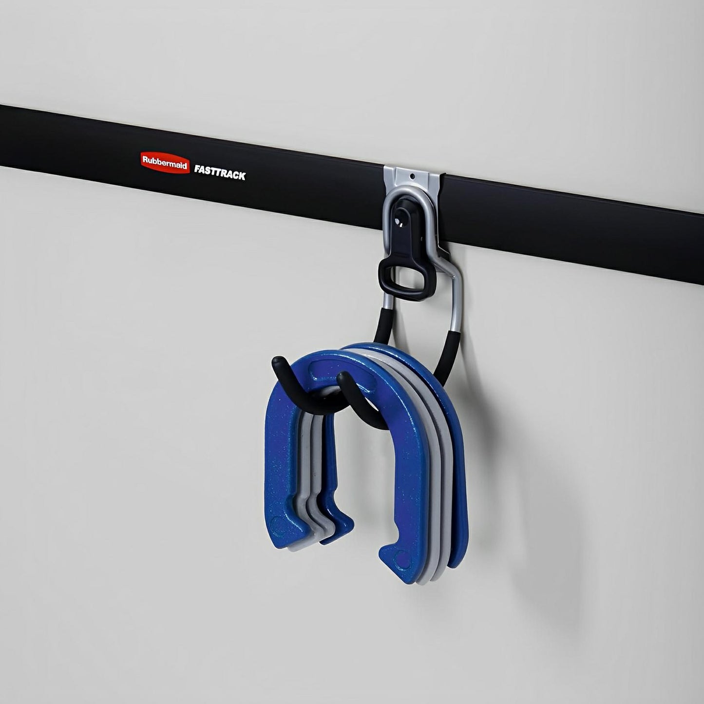 Rubbermaid FastTrack storage system with multi-purpose hook holding blue weights, showcasing organized vertical storage solution.