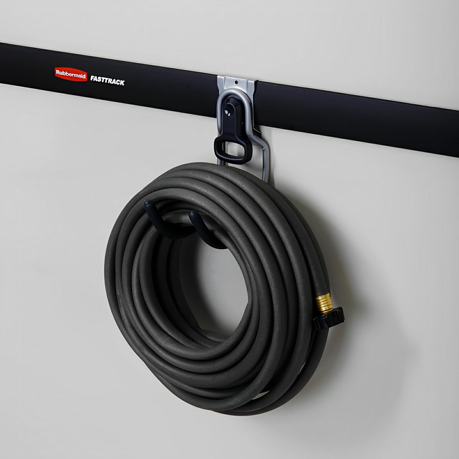 Rubbermaid FastTrack wall utility hook holding a coiled hose on a shed wall, showcasing durable and secure storage solution.