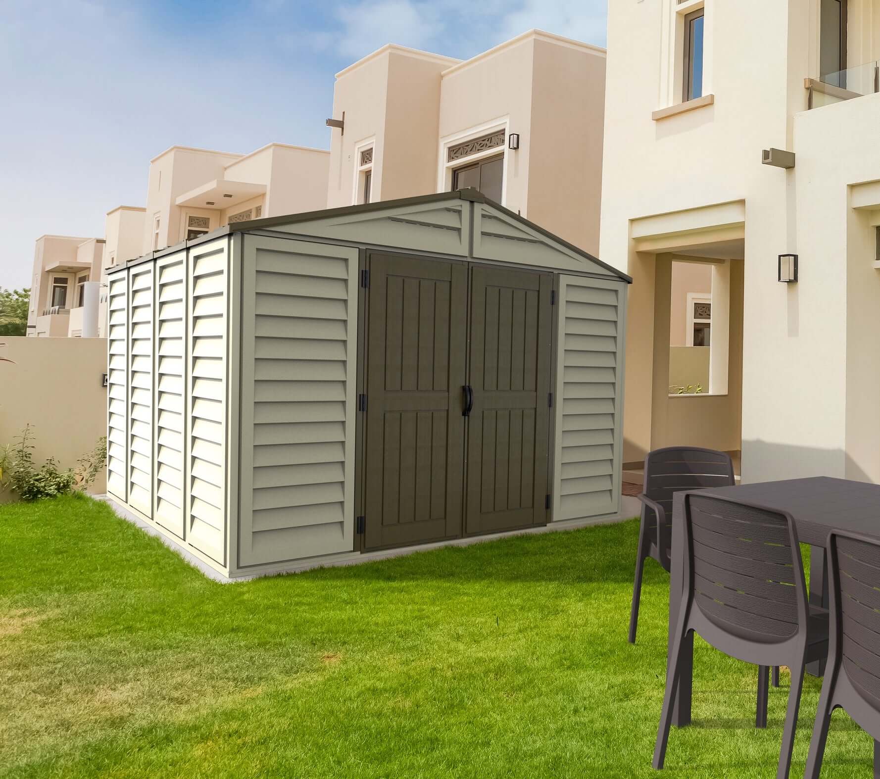 Duramax 10.5x10.5 Woodbridge PLUS Vinyl Shed with foundation in backyard setting.
