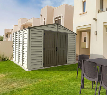 Duramax 10.5x10.5 Woodbridge PLUS Vinyl Shed with foundation in backyard setting.