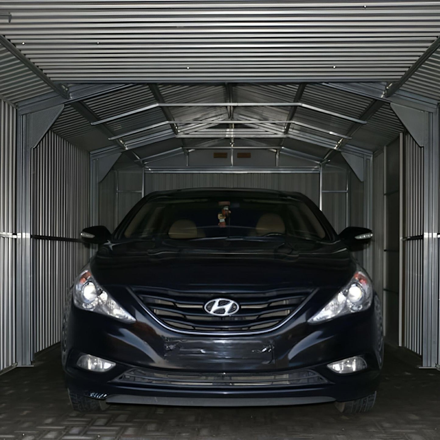 Duramax Imperial Metal Garage interior with car, showcasing robust steel construction and durability.