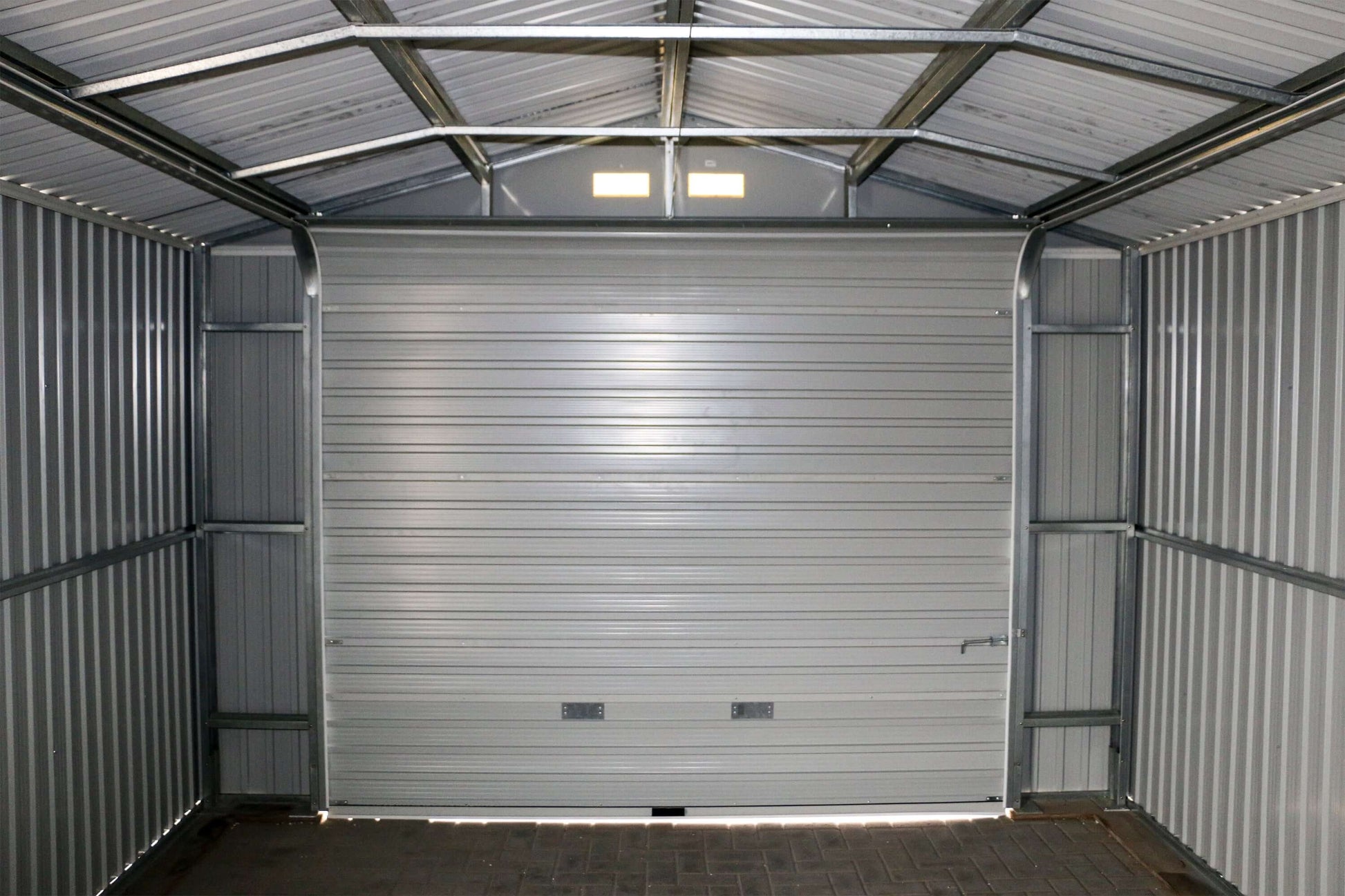 Interior view of Duramax 12x20 Imperial Metal Garage in dark gray, showcasing the all-metal roof system and steel structure for durability.