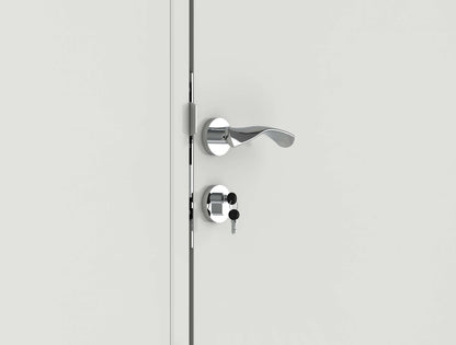 Close-up of a modern silver door handle with a key inserted in the lock.