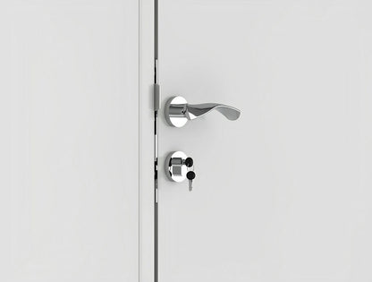 Close-up of a modern silver door handle with a keyhole on a white door, showcasing a sleek and contemporary design.