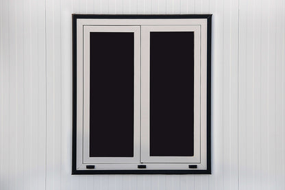 White frame double window on a modern insulated building exterior wall
