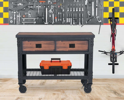 Duramax 2-Drawer Rolling Industrial Workbench with caster wheels in a garage setting with tools, ideal for storage and workspace.