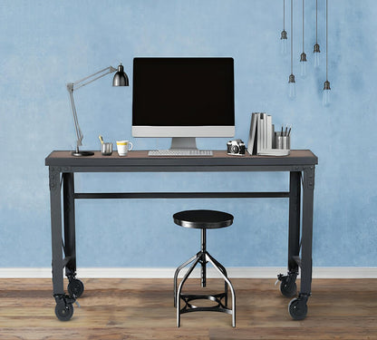 Duramax 62x24 inch industrial rolling worktable with wooden top, black metal frame, caster wheels, and desk setup in a modern room.