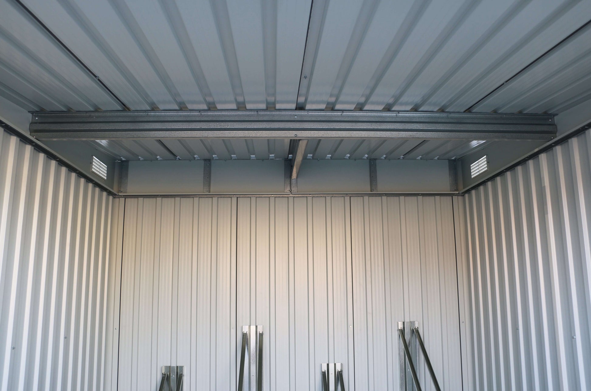 Interior view of sturdy Duramax 6x6 Bike Shed showing metal panels and solid construction. Ideal for secure bike storage. Keywords: duramax sheds.