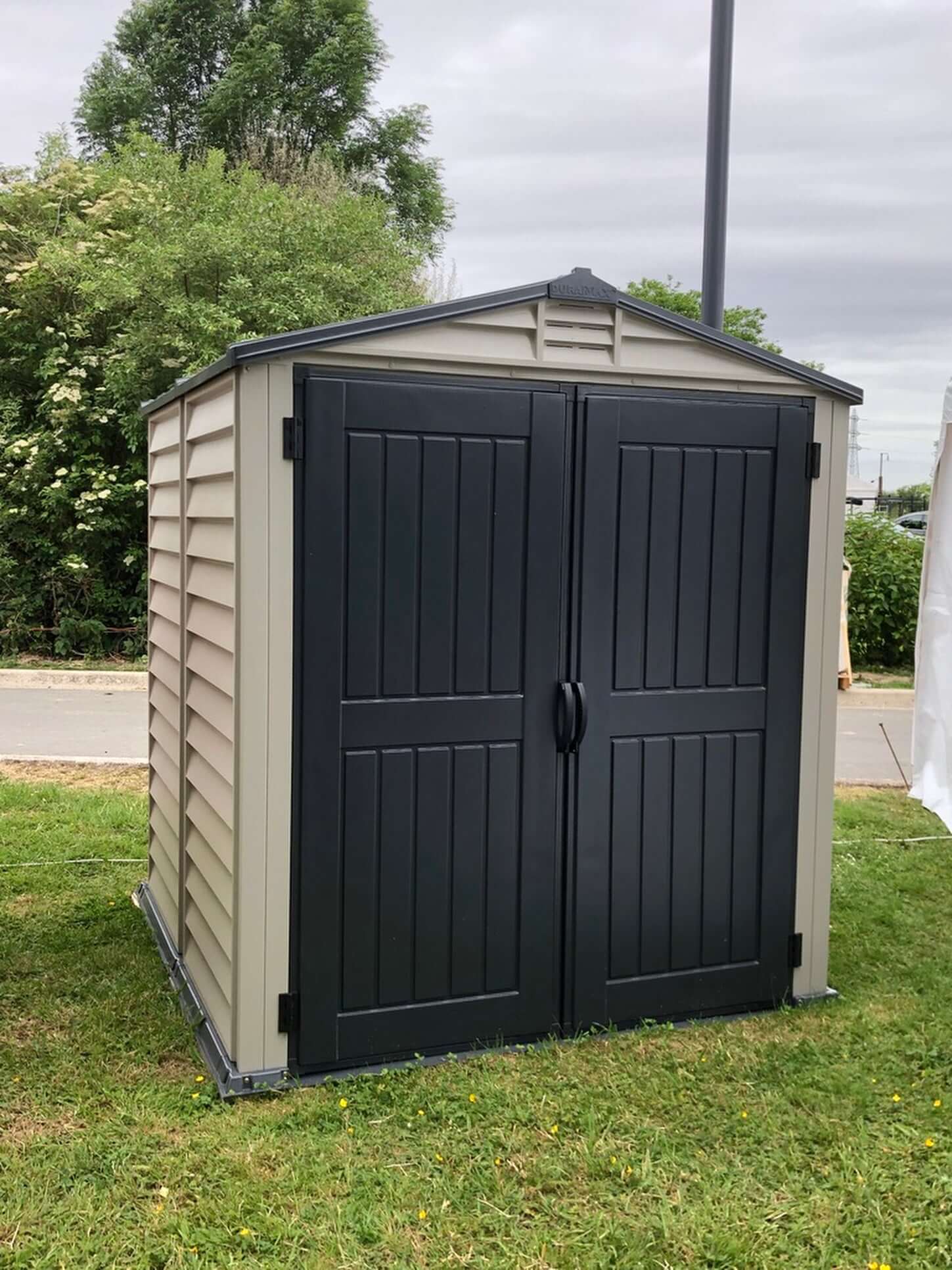 Duramax 6x6 StoreMate PLUS vinyl shed with floor, showcasing robust double-entry doors and fire-retardant vinyl construction.