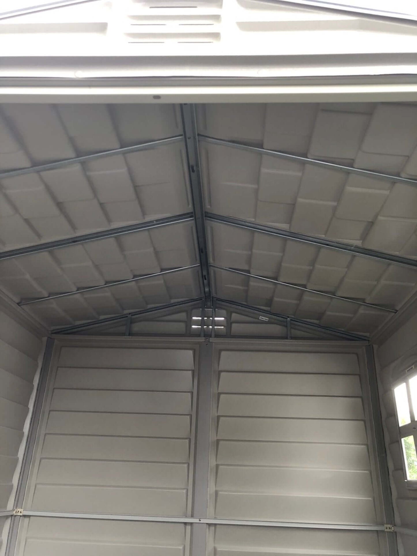 Interior view of Duramax 6x6 StoreMate PLUS Vinyl Shed showcasing galvanized steel beams and spacious design for secure storage.