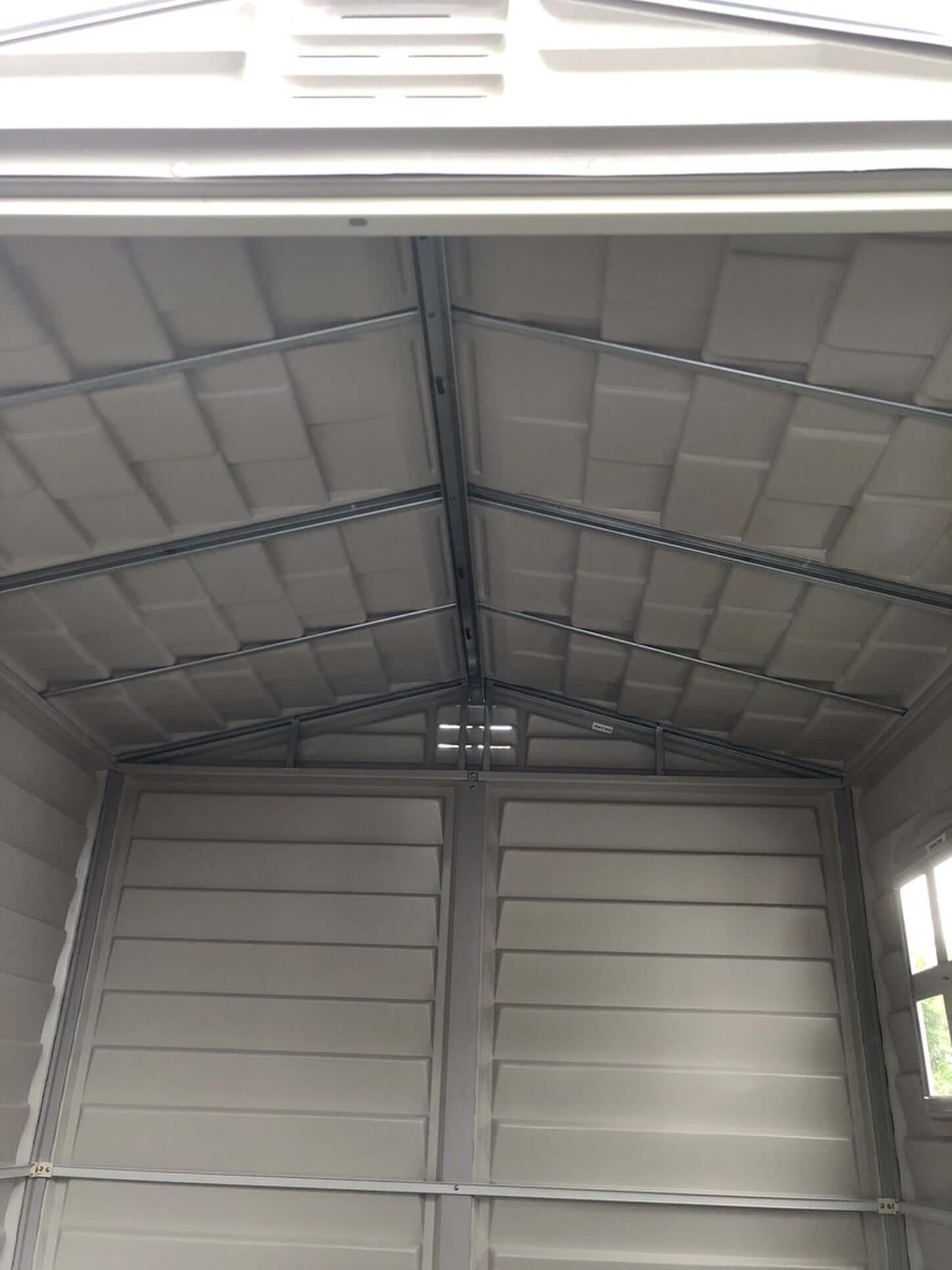 Interior view of Duramax 6x6 StoreMate PLUS Vinyl Shed showcasing galvanized steel beams and spacious design for secure storage.