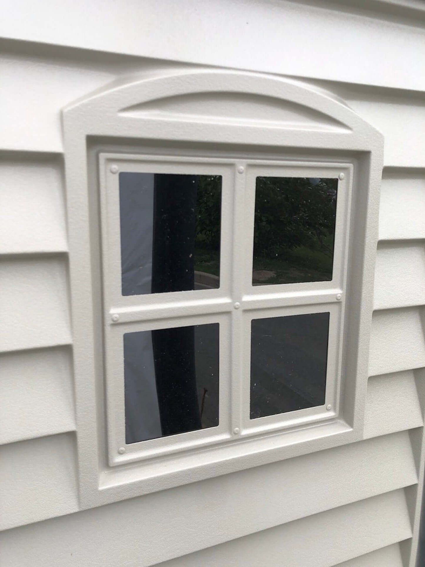 Close-up of a window on a Duramax 6x6 StoreMate PLUS Vinyl Shed, showcasing detailed craftsmanship and premium materials.