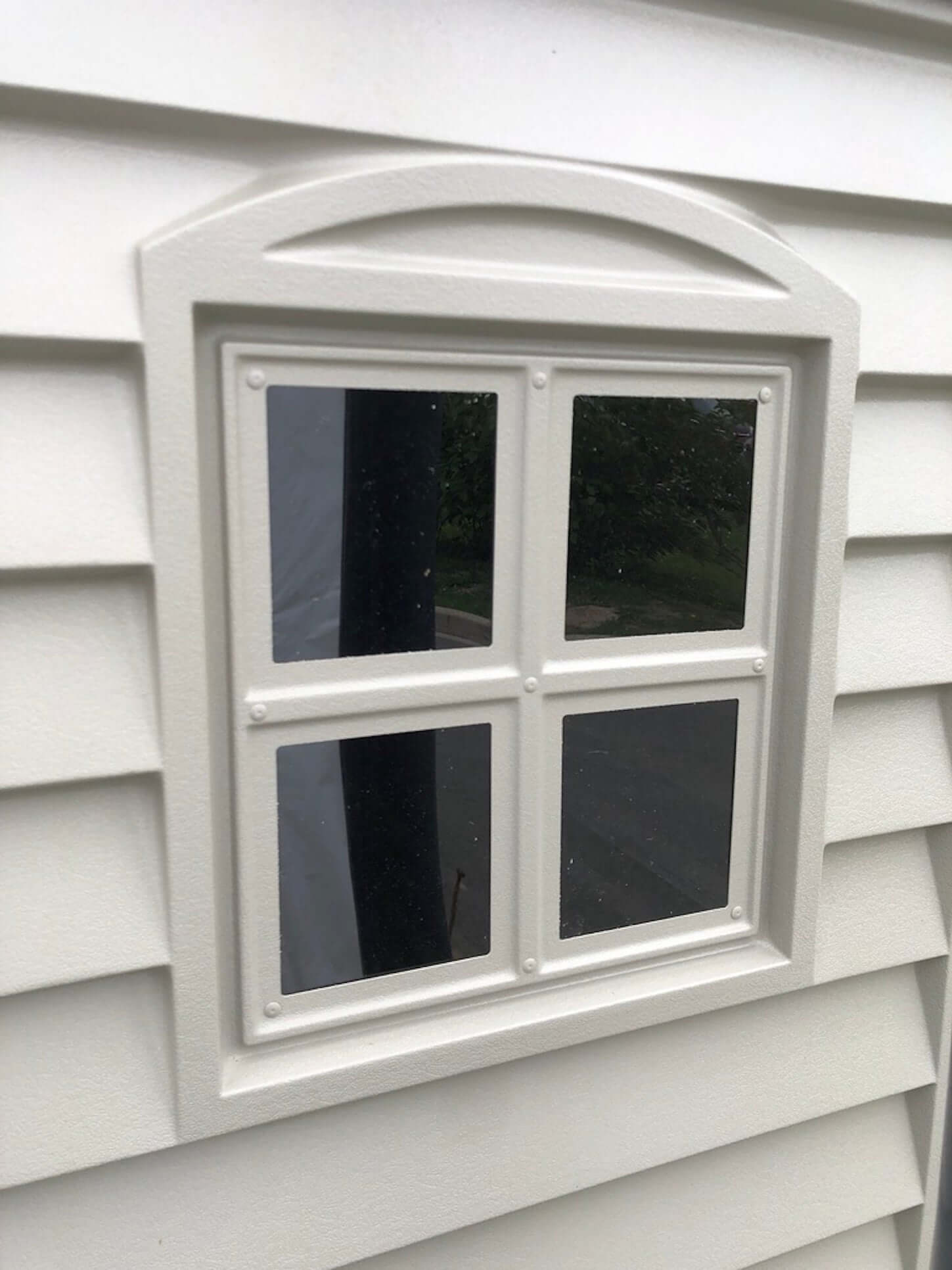 Close-up of a window on a Duramax 6x6 StoreMate PLUS Vinyl Shed, showcasing detailed craftsmanship and premium materials.