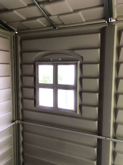 Interior view of Duramax 6x6 StoreMate PLUS shed showing vinyl panels and window design.
