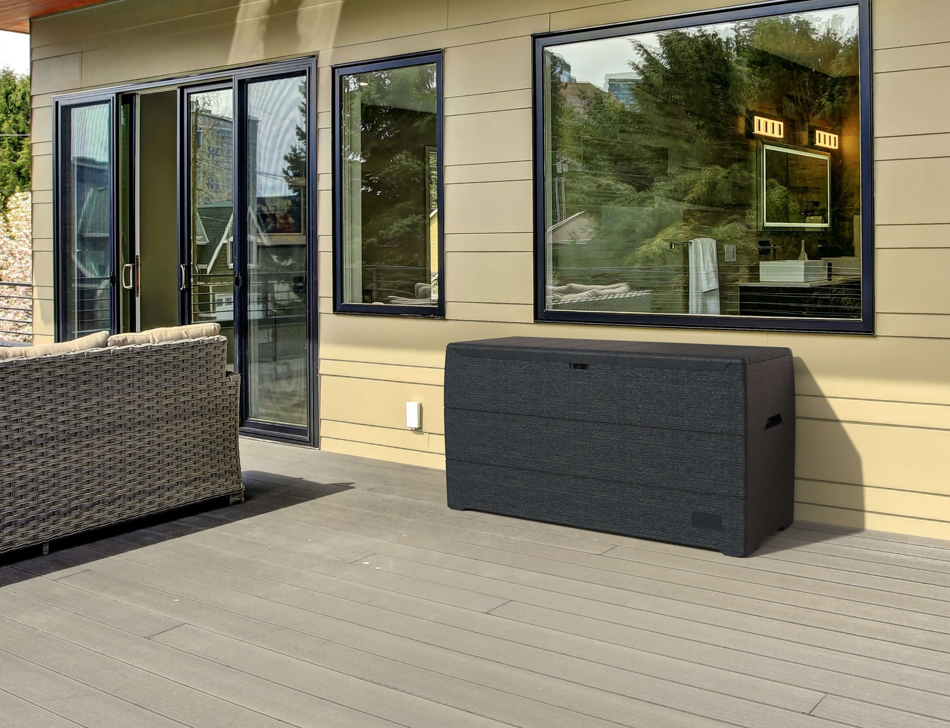 Duramax 71 Gallon Deck Box Gray on patio, providing stylish storage and seating for outdoor spaces, made of durable polypropylene resin.