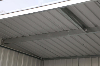 Interior view of Duramax 8x6 Metal Shed with pent roof and skylight, showcasing structural design. Keywords: duramax sheds, duramax shed.