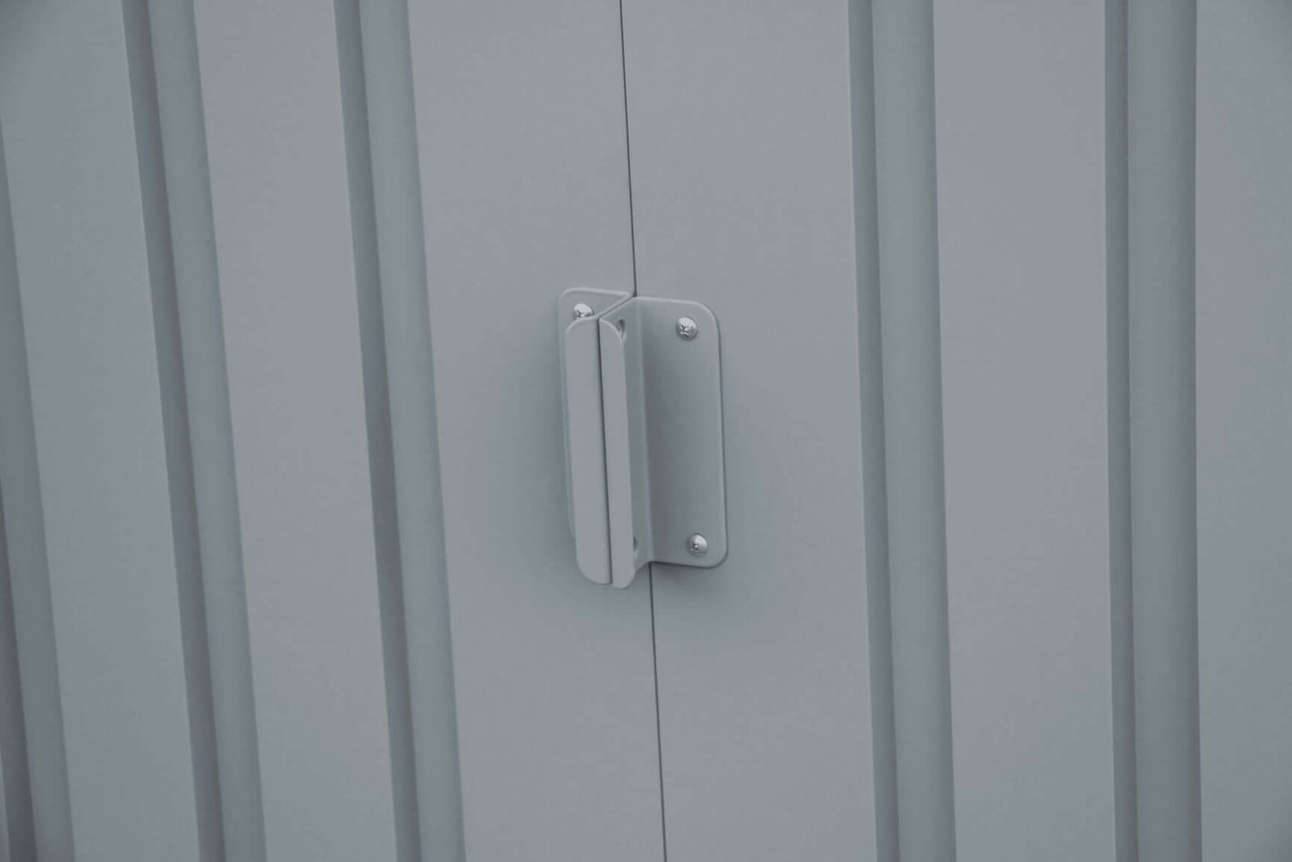 Close-up of a metal handle on the door of a Duramax 8x6 metal shed with skylight.