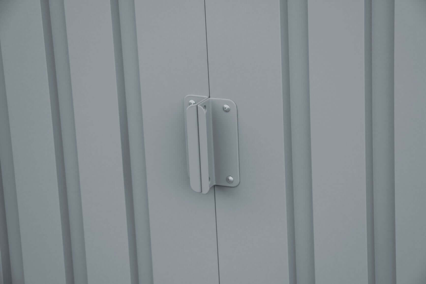 Close-up of a metal handle on the door of a Duramax 8x6 metal shed with skylight.