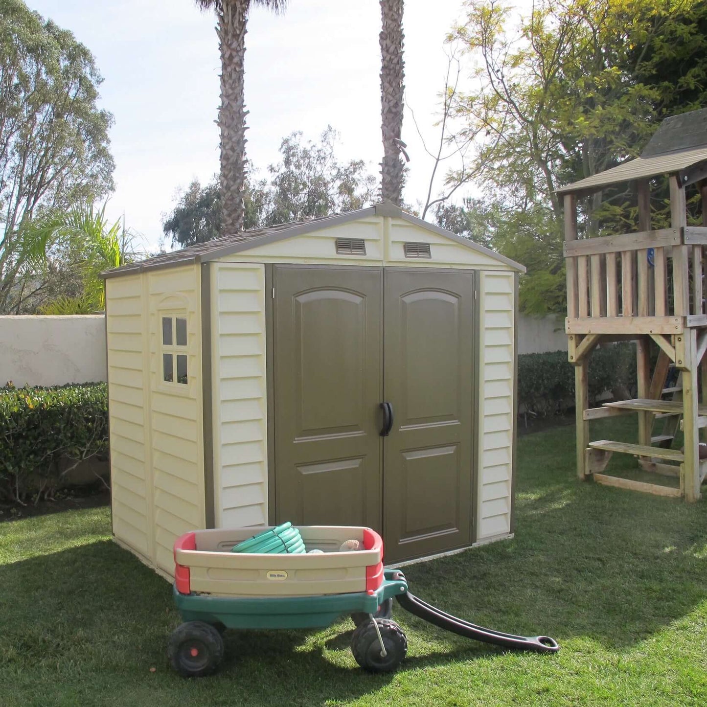 Duramax 8x6 StoreAll Vinyl Shed in backyard, ideal storage solution for families. Features reinforced metal columns. Duramax shed.
