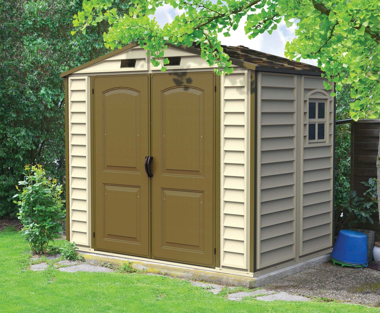 Duramax 8x6 StoreAll Vinyl Shed with foundation in a garden, ideal outdoor storage solution. Keywords: Duramax shed, Duramax Sheds.