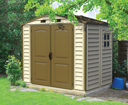Duramax 8x6 StoreAll Vinyl Shed with foundation in a garden, ideal outdoor storage solution. Keywords: Duramax shed, Duramax Sheds.