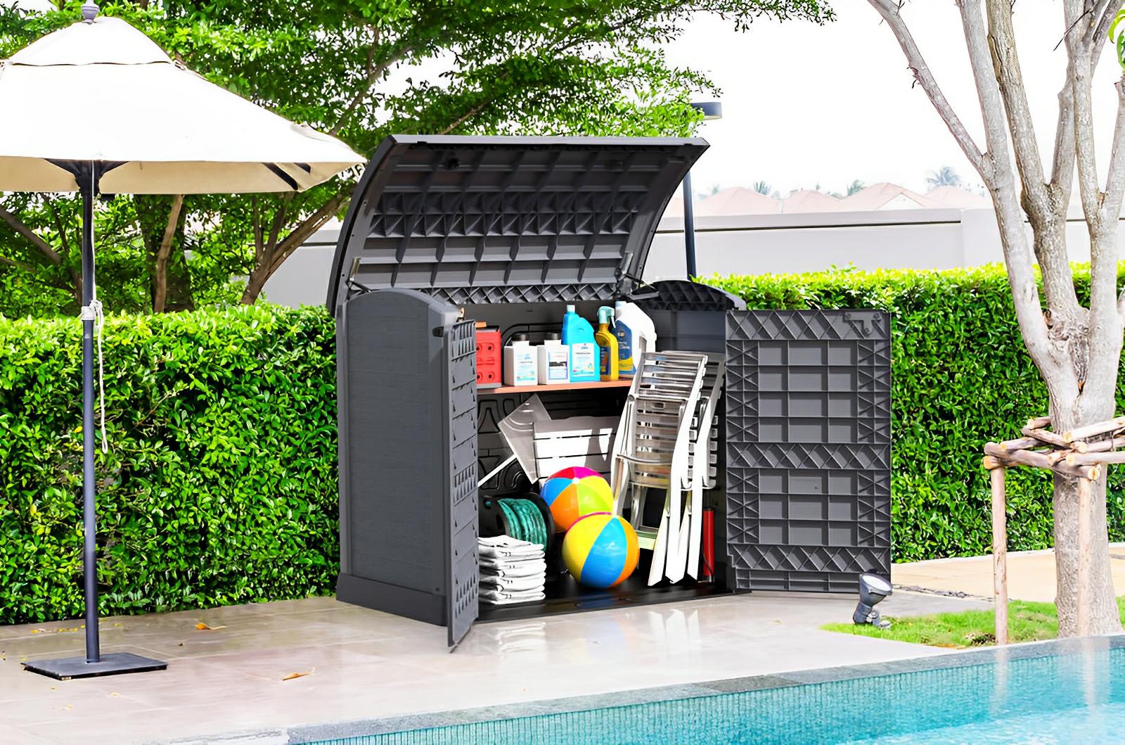 Duramax StoreAway garden shed by poolside, open to show organization of gardening tools, sports equipment, and outdoor accessories.