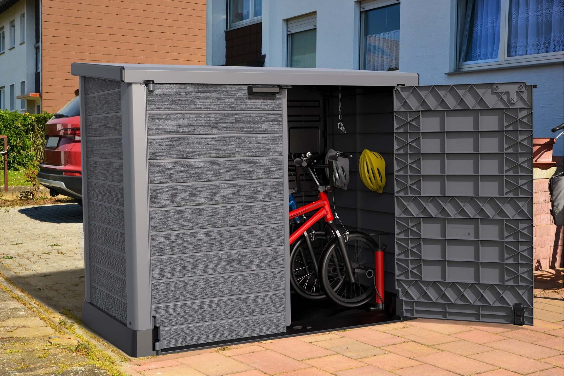 Duramax StoreAway garden shed with flat lid, open to reveal bicycles and helmets, showcasing spacious outdoor storage solution.