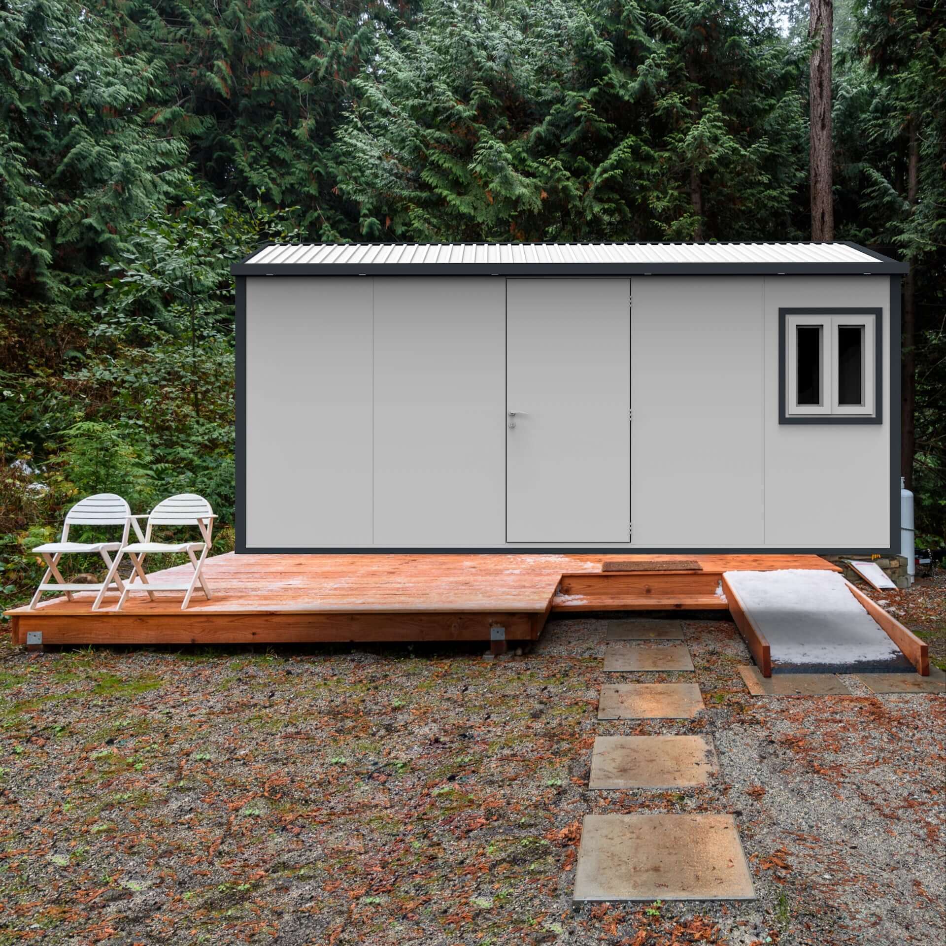 Duramax 16x10 insulated shed with gable roof on a wooden platform surrounded by trees.